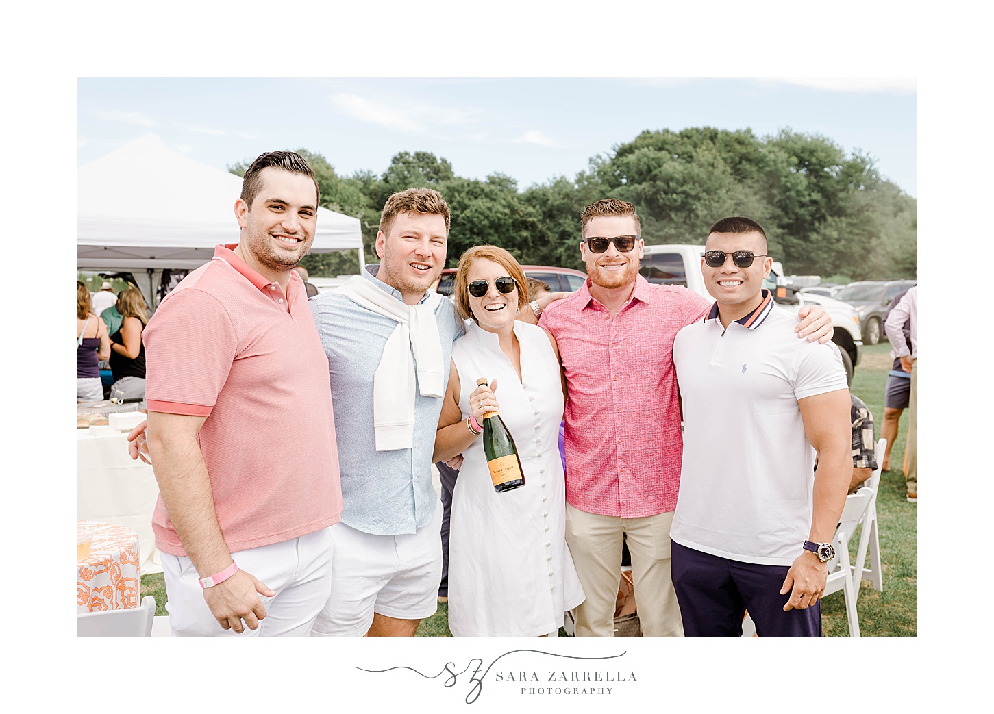 bride holds champagne at Newport Polo match