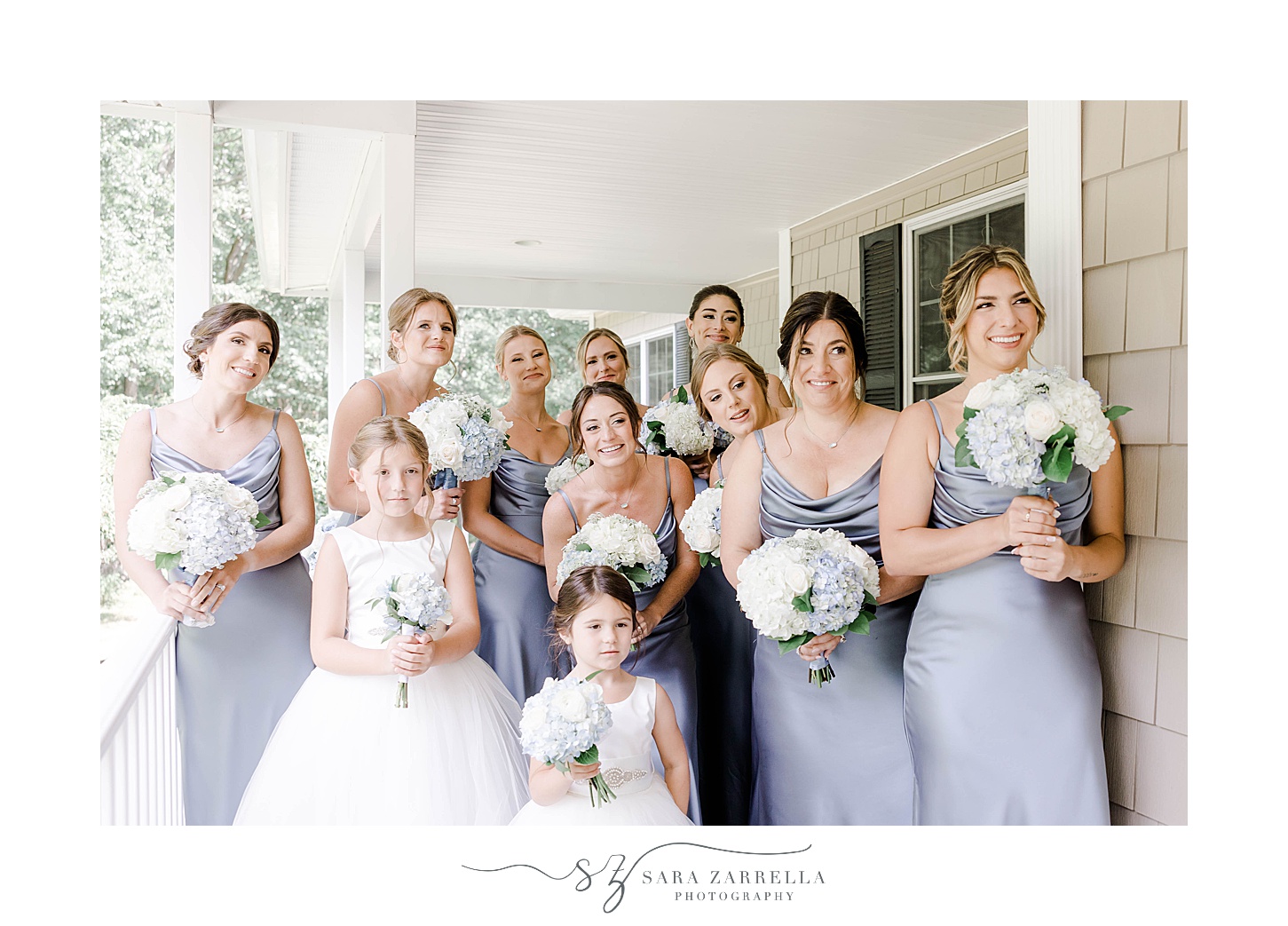 bridesmaids in blue gowns react to bride during first look