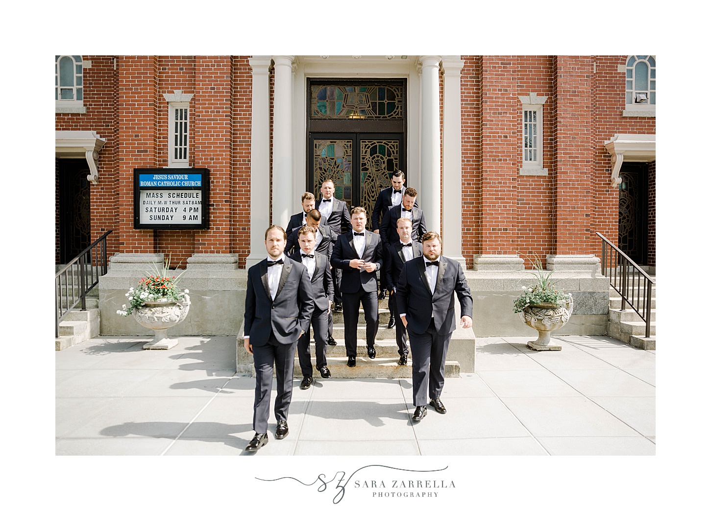 groom and groomsmen walk down church steps in Rhode Island