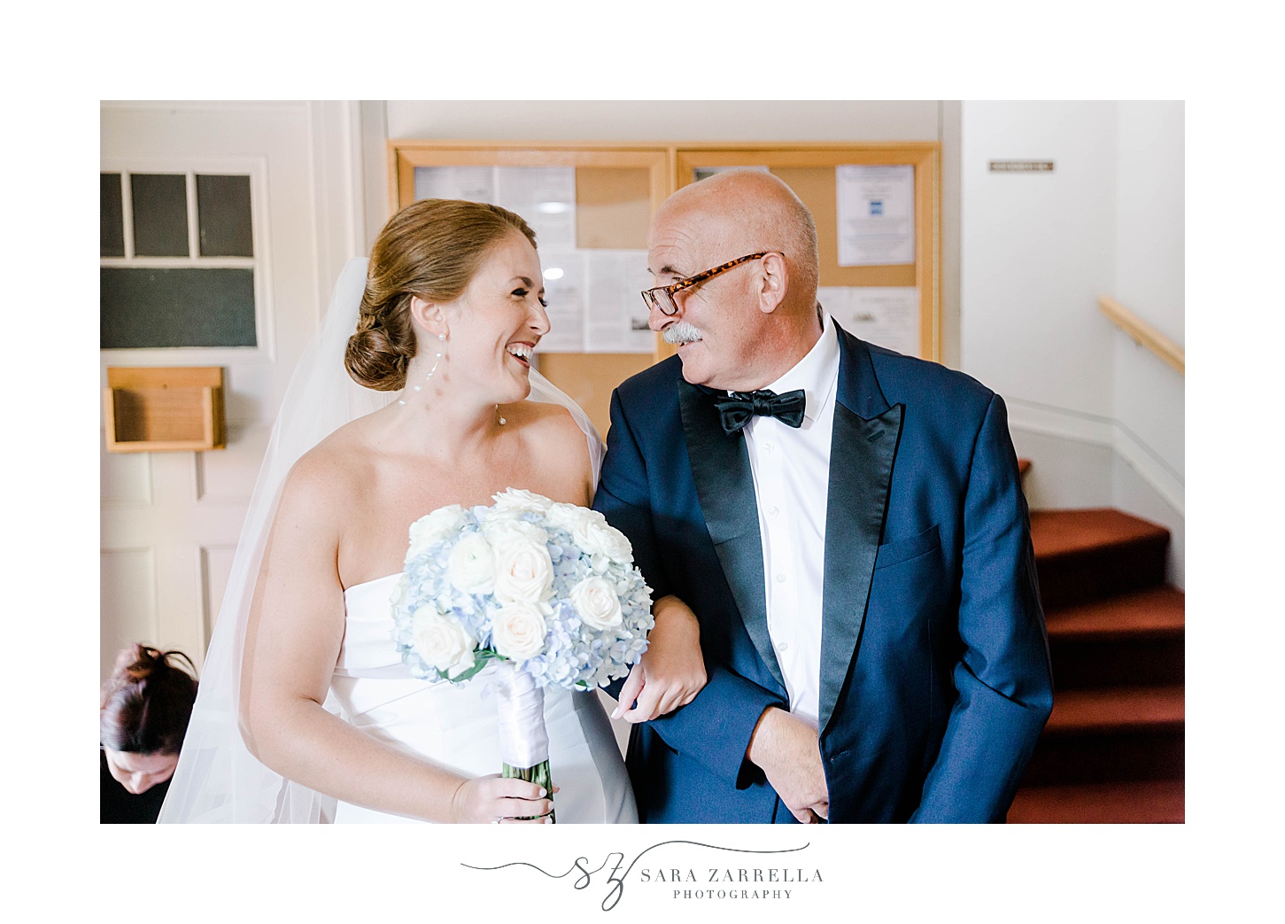 dad and bride smile together before entering church for traditional church wedding in Rhode Island