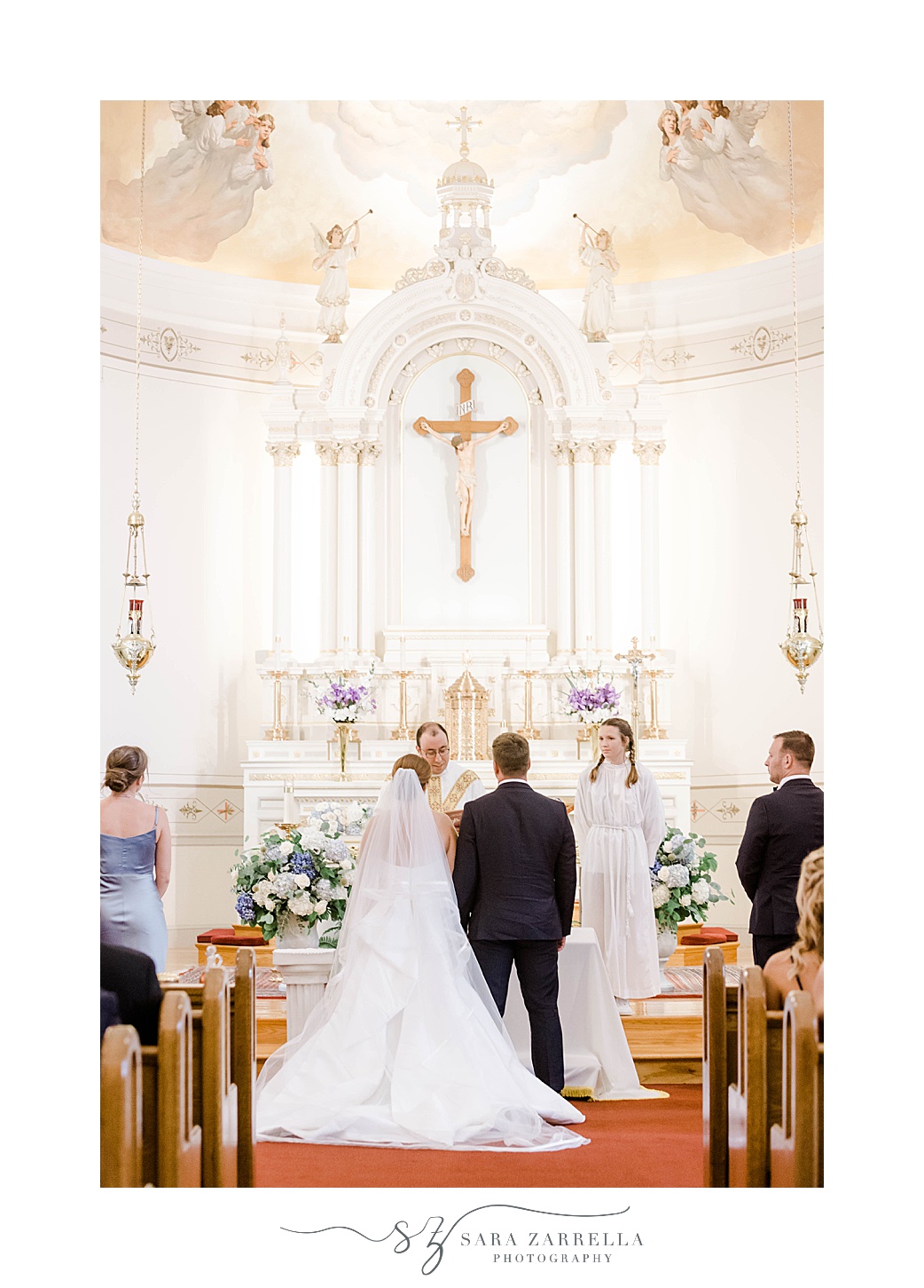 bride and groom stand at alter during traditional church wedding in Rhode Island