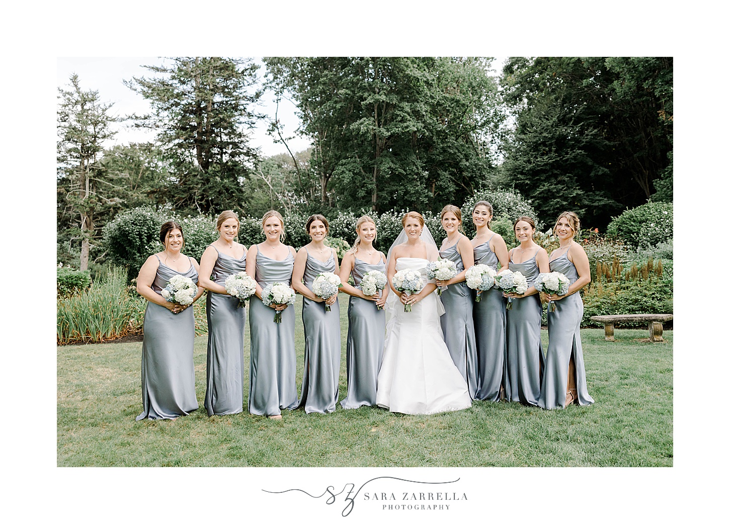 bridesmaids in blue gowns walk with bride at Glen Manor House