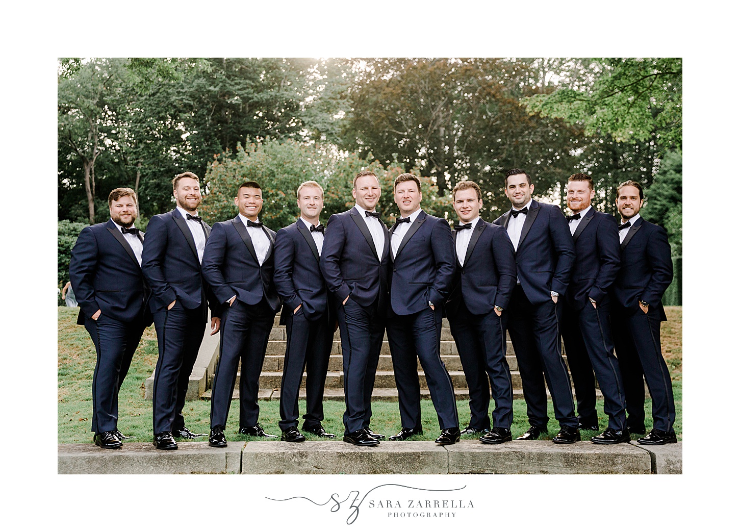 groom in navy suit poses with groomsmen at Glen Manor House