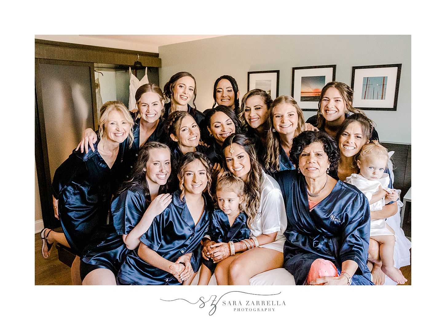 bride sits with bridesmaids in matching robes in Newport RI