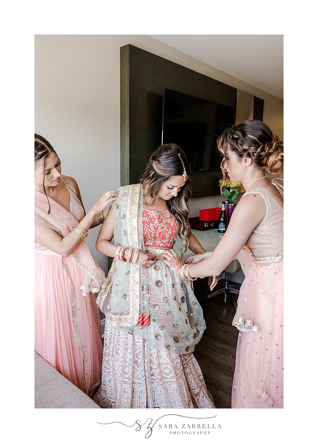 bridesmaids help bride with sari for Indian wedding at Newport Beach House