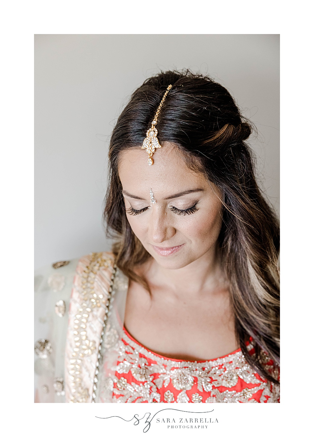 bride poses with jewelry during prep for Indian wedding at Newport Beach House