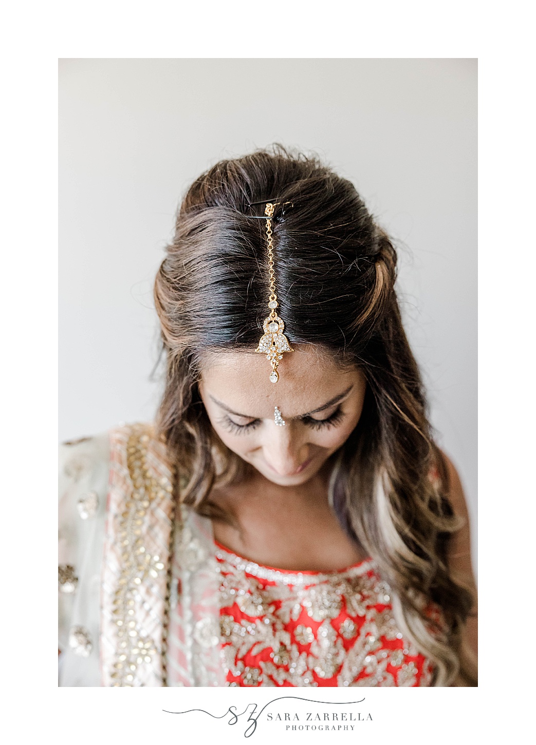 bride shows off gold jewelry before Indian wedding at Newport Beach House