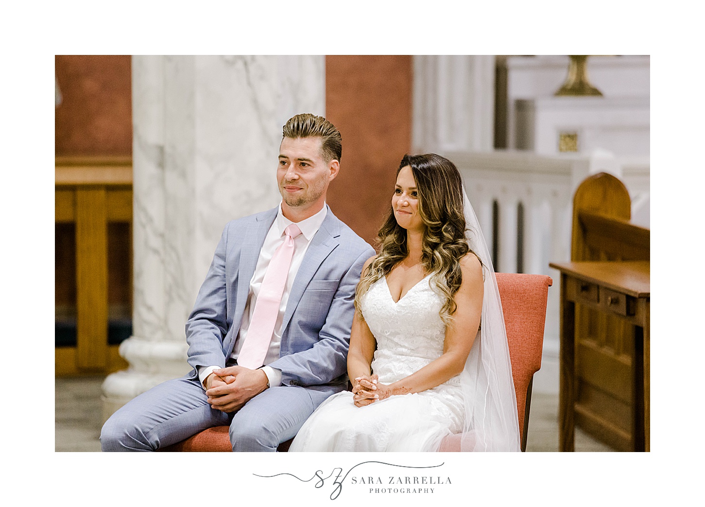 bride and groom sit together during Catholic wedding day in Newport RI