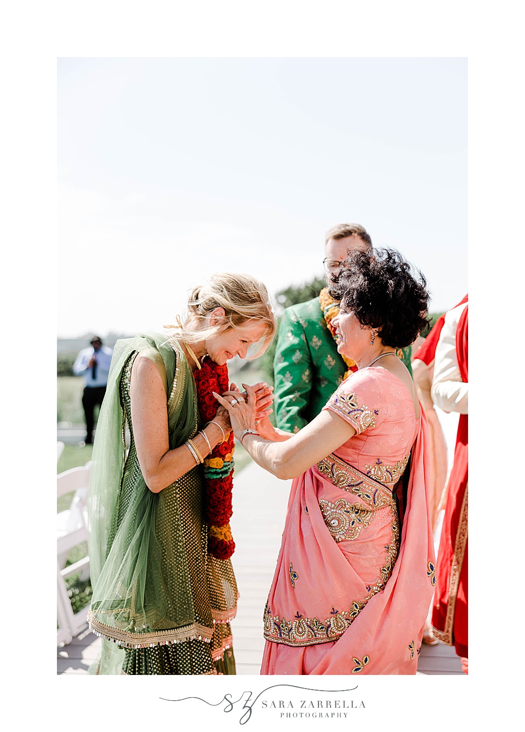mothers hold hands during traditional Indian wedding ceremony at Newport Beach House