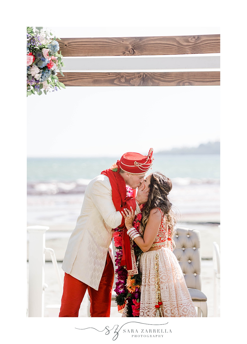 newlyweds kiss after traditional Indian wedding ceremony at Newport Beach House