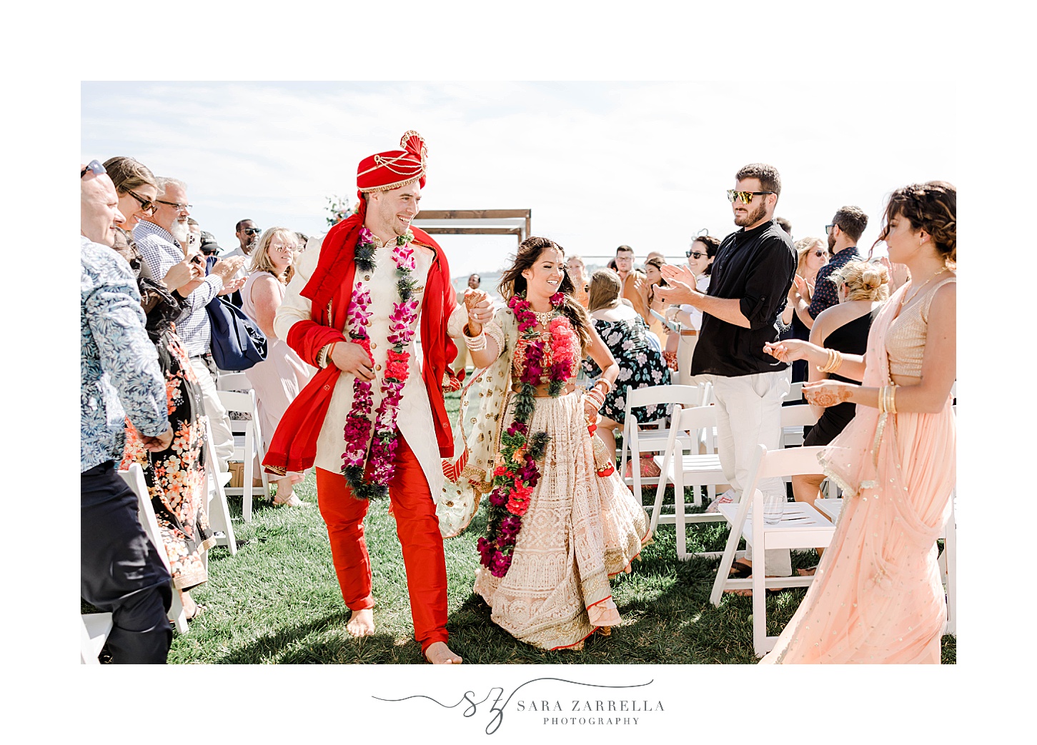 couple walks up aisle after traditional Indian wedding ceremony at Newport Beach House