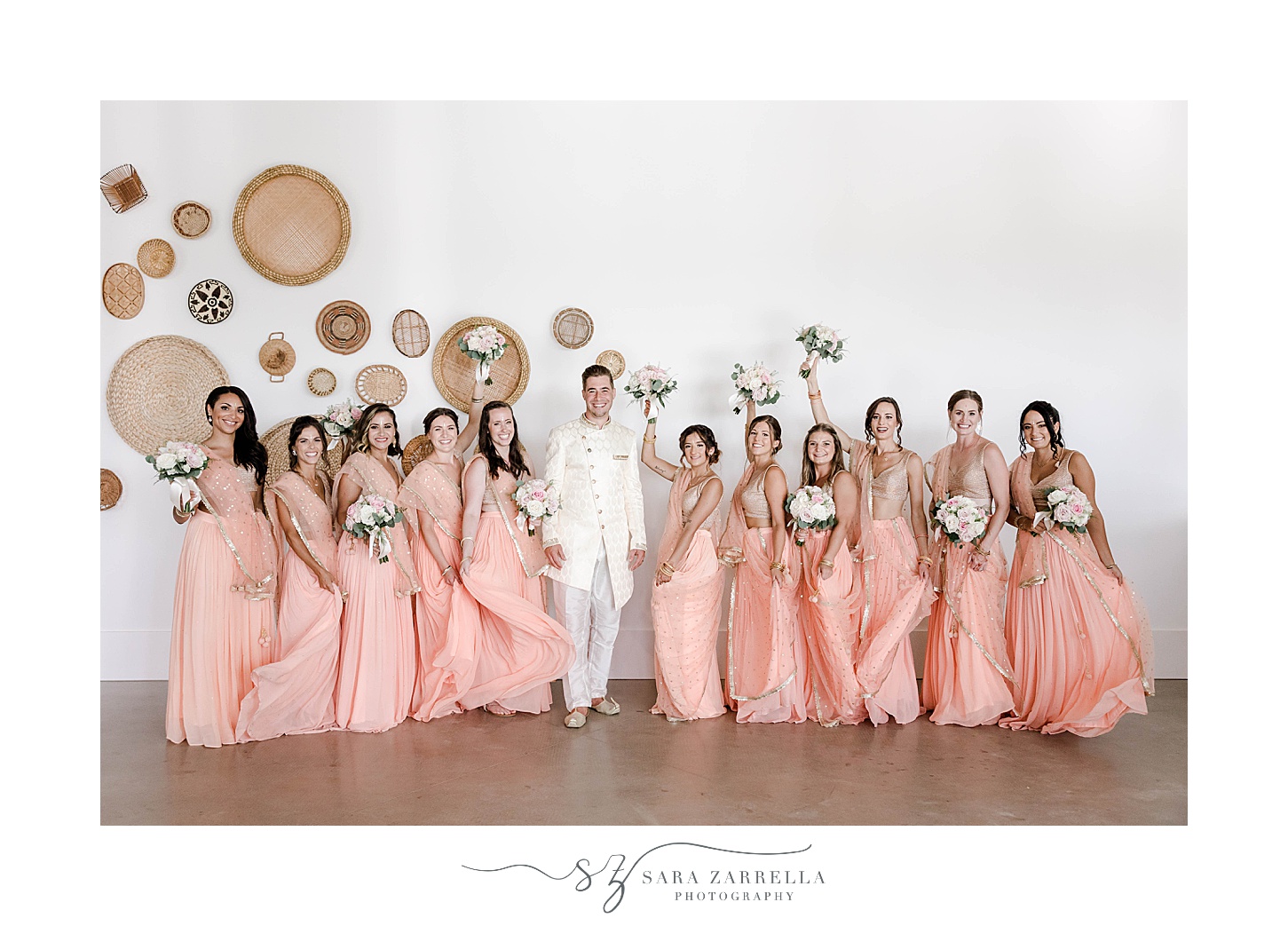 groom stands with bridesmaids in sarees at Newport Beach House