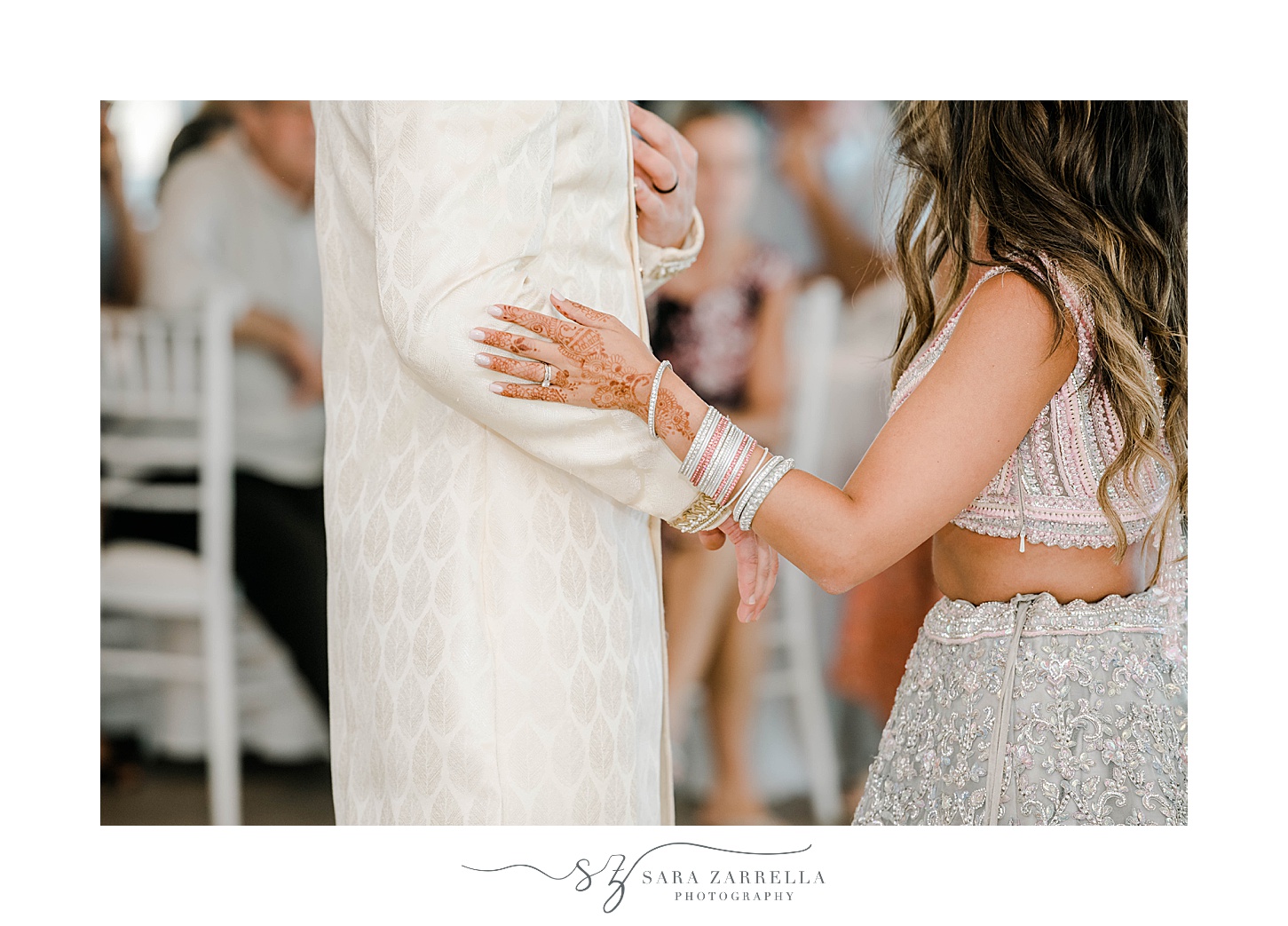 bride holds groom's arm during first dance at Newport Beach House