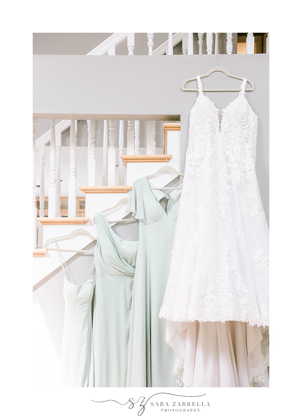 bride's dress hangs with mint green bridesmaid dresses