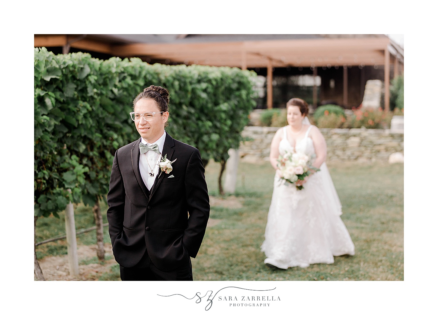 bride approches groom in vines for first look at Newport Vineyards