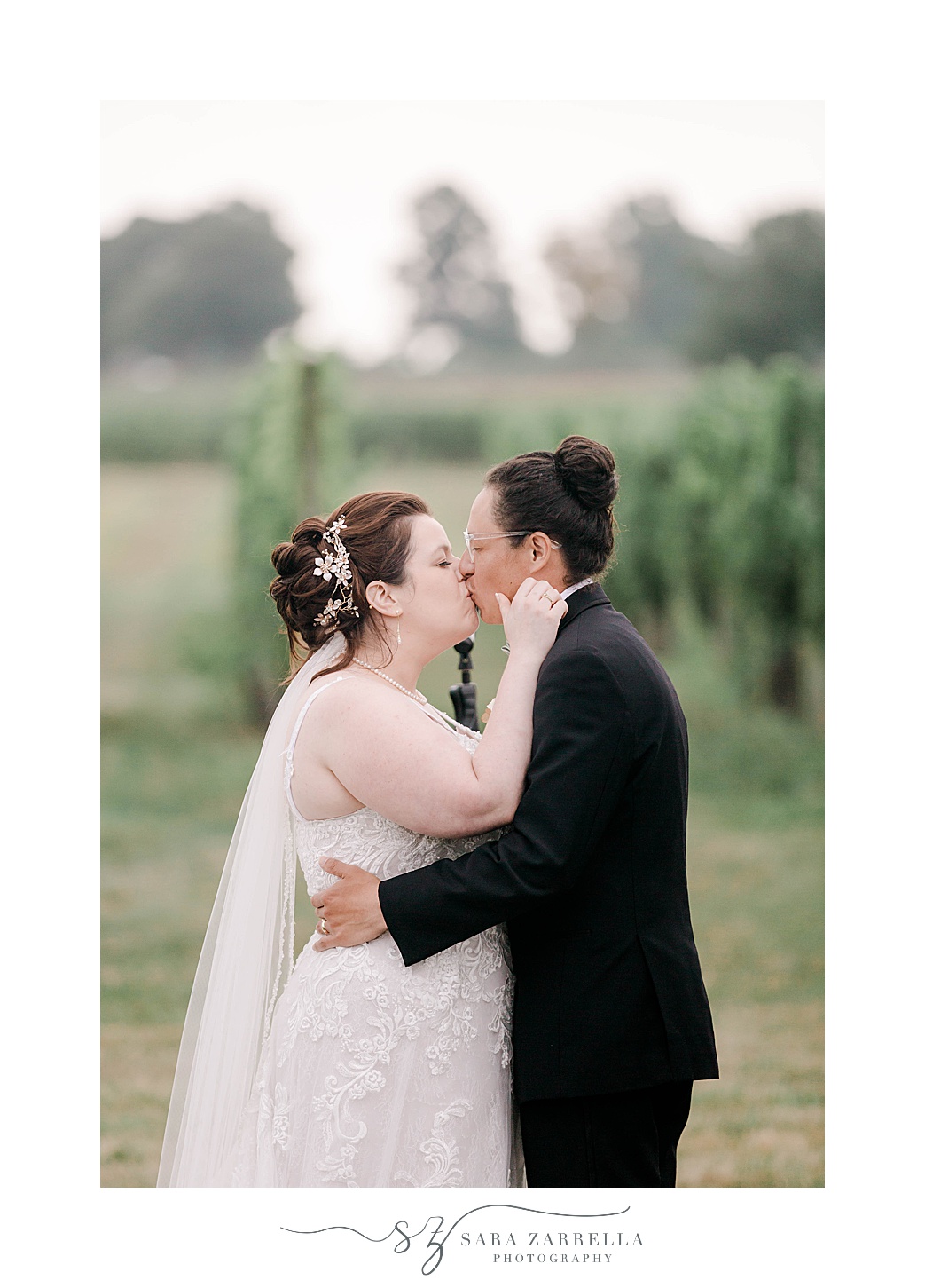 newlyweds kiss during Newport Vineyards wedding ceremony