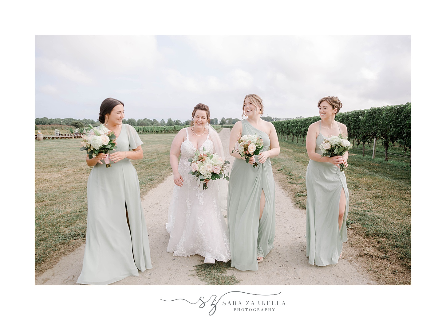 bride walks with bridesmaids in mint green gowns at Newport Vineyards