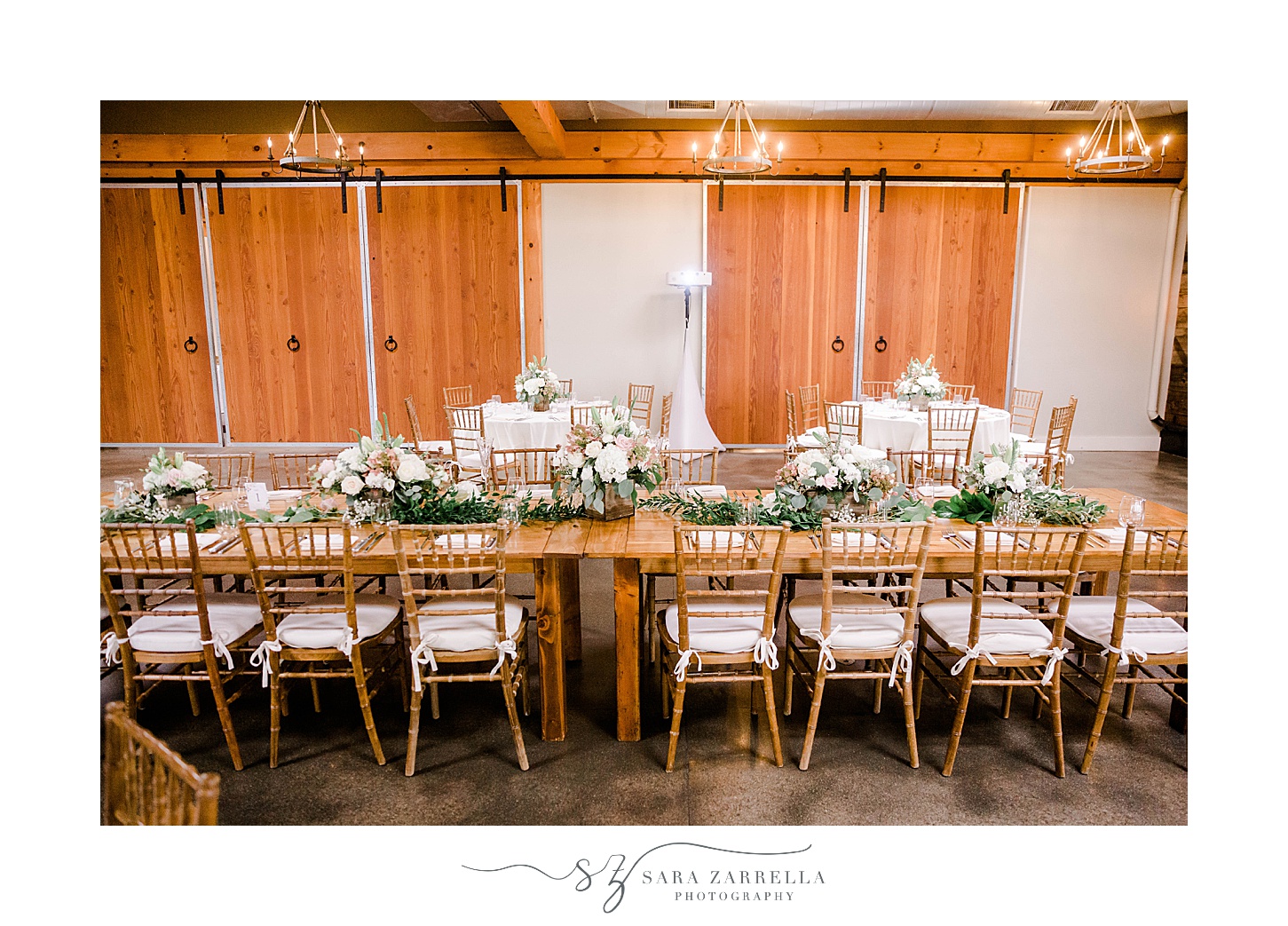 long wooden table with floral centerpieces at Newport Vineyards