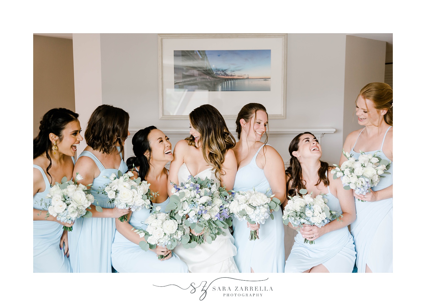 bride laughs with bridesmaids in blue gowns before Regatta Place wedding
