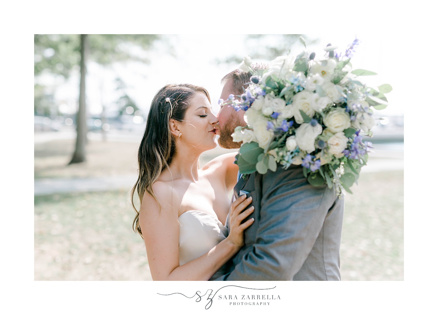 bride and groom kiss during Rhode Island wedding portraits 