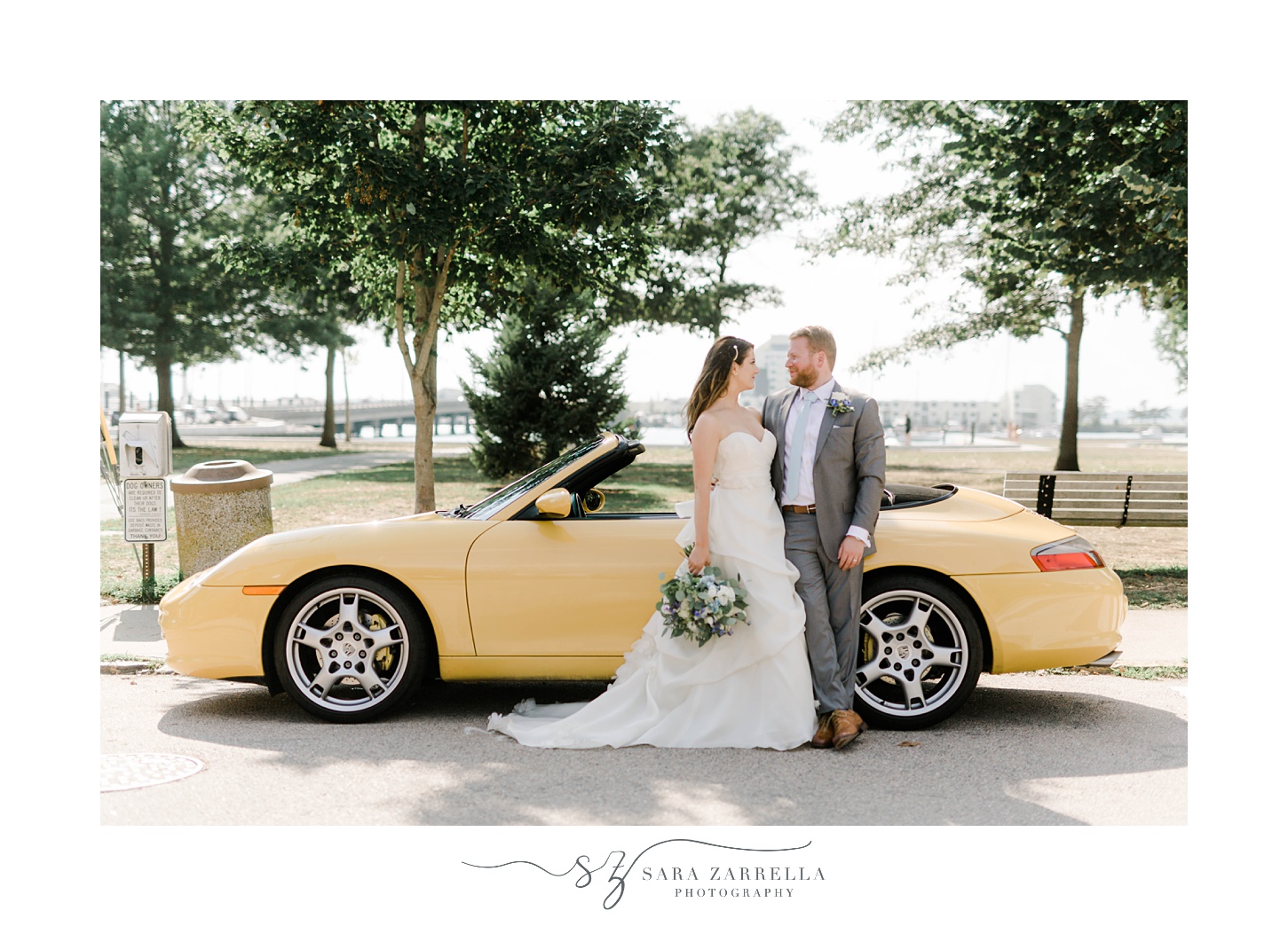 bride and groom pose by yellow sports car in Newport RI