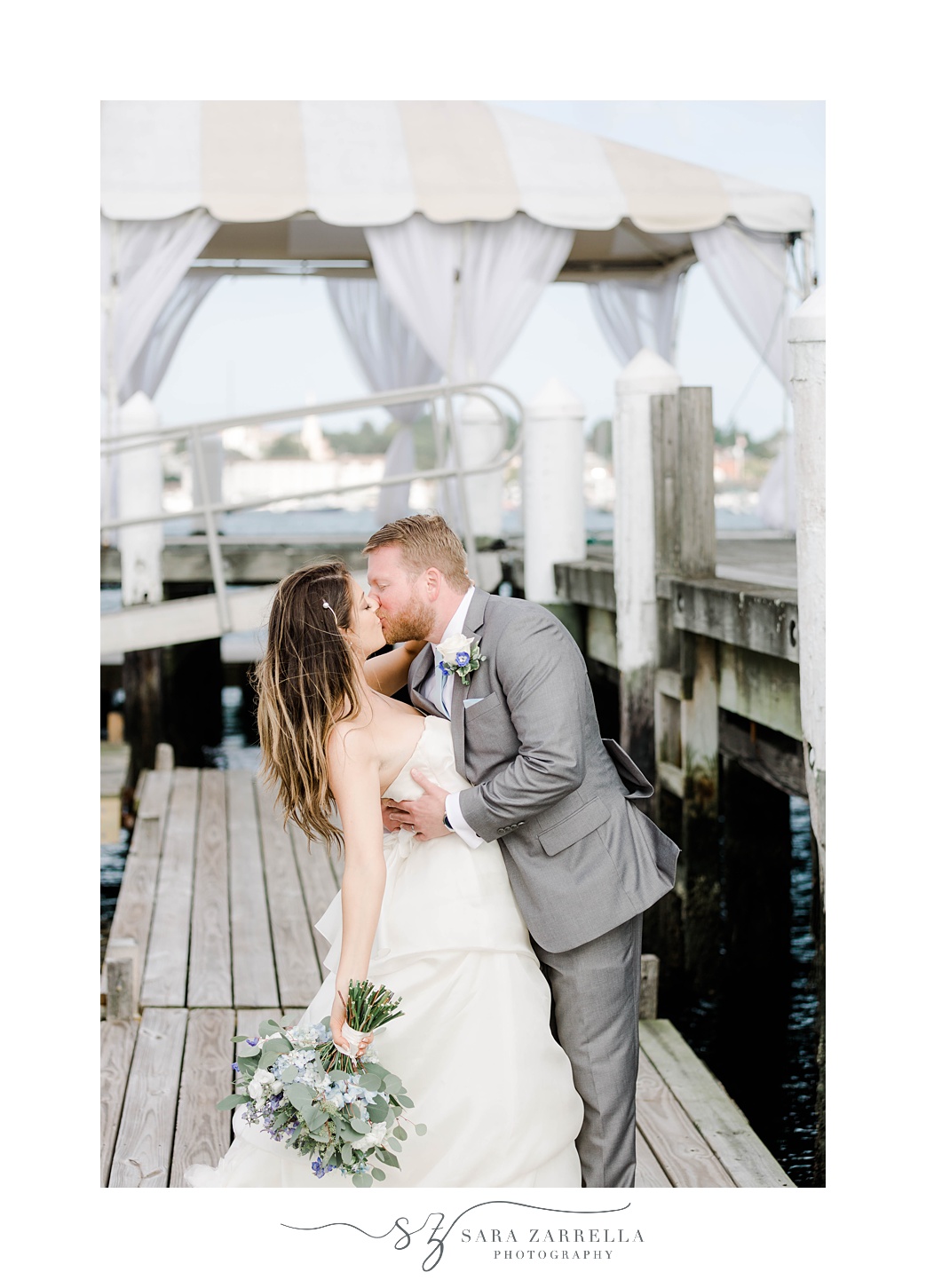 groom dips bride during kiss on docks in Newport RI
