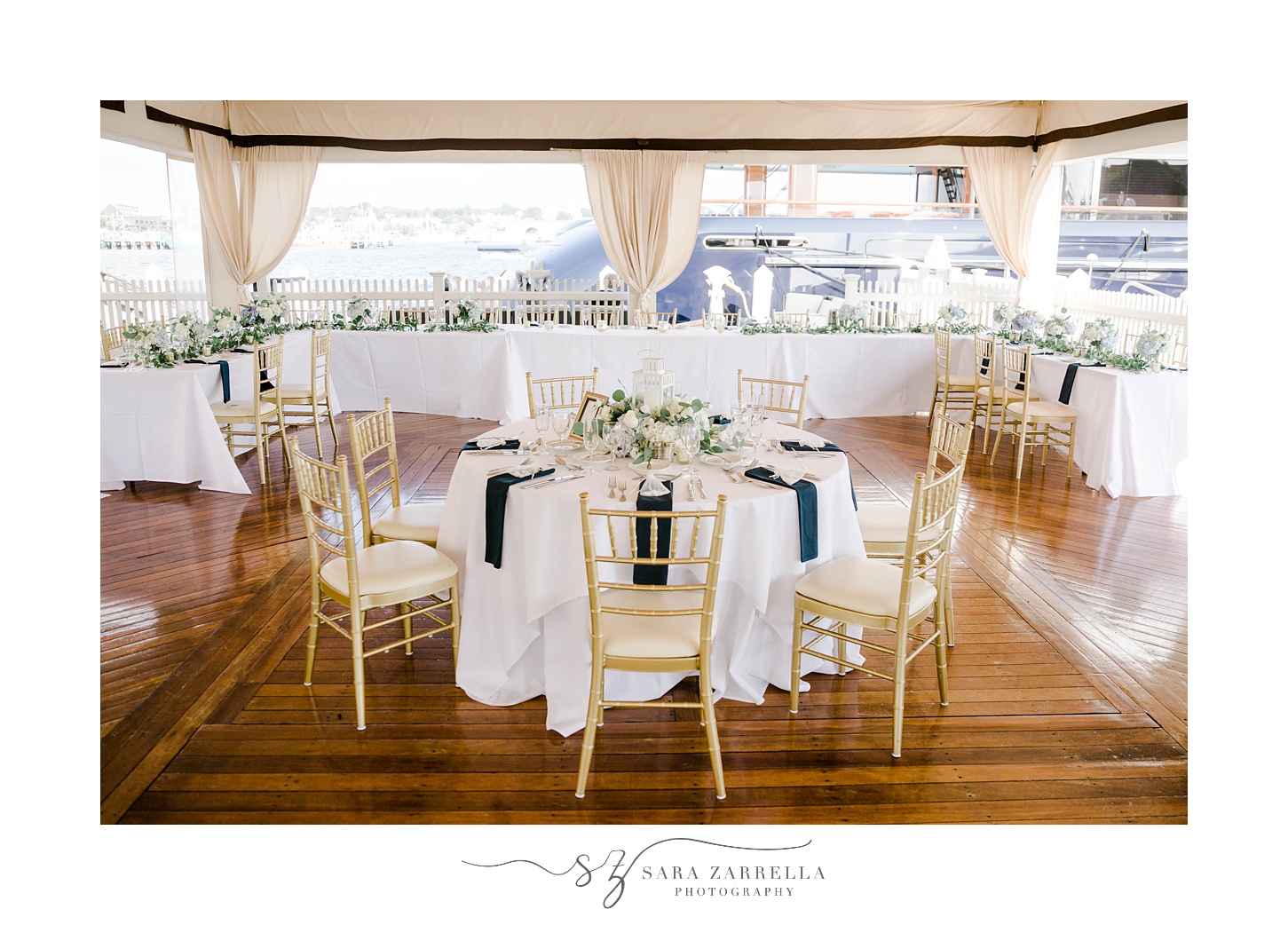 Regatta Place wedding reception with navy napkins and gold chairs