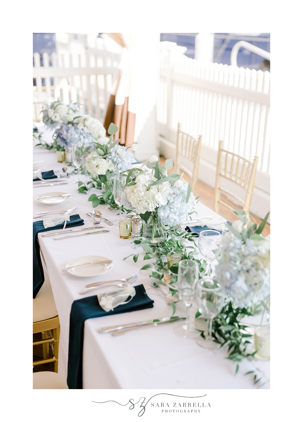 tables for reception with blue and green florals at Regatta Place