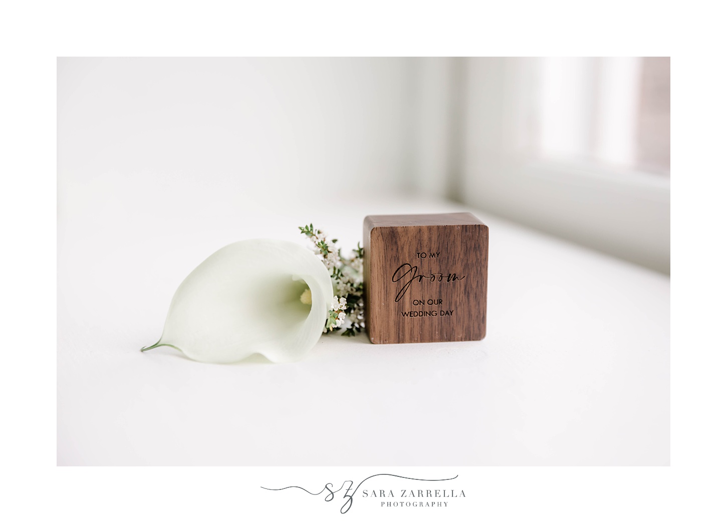 groom's calla lily boutonniere and wooden ring box