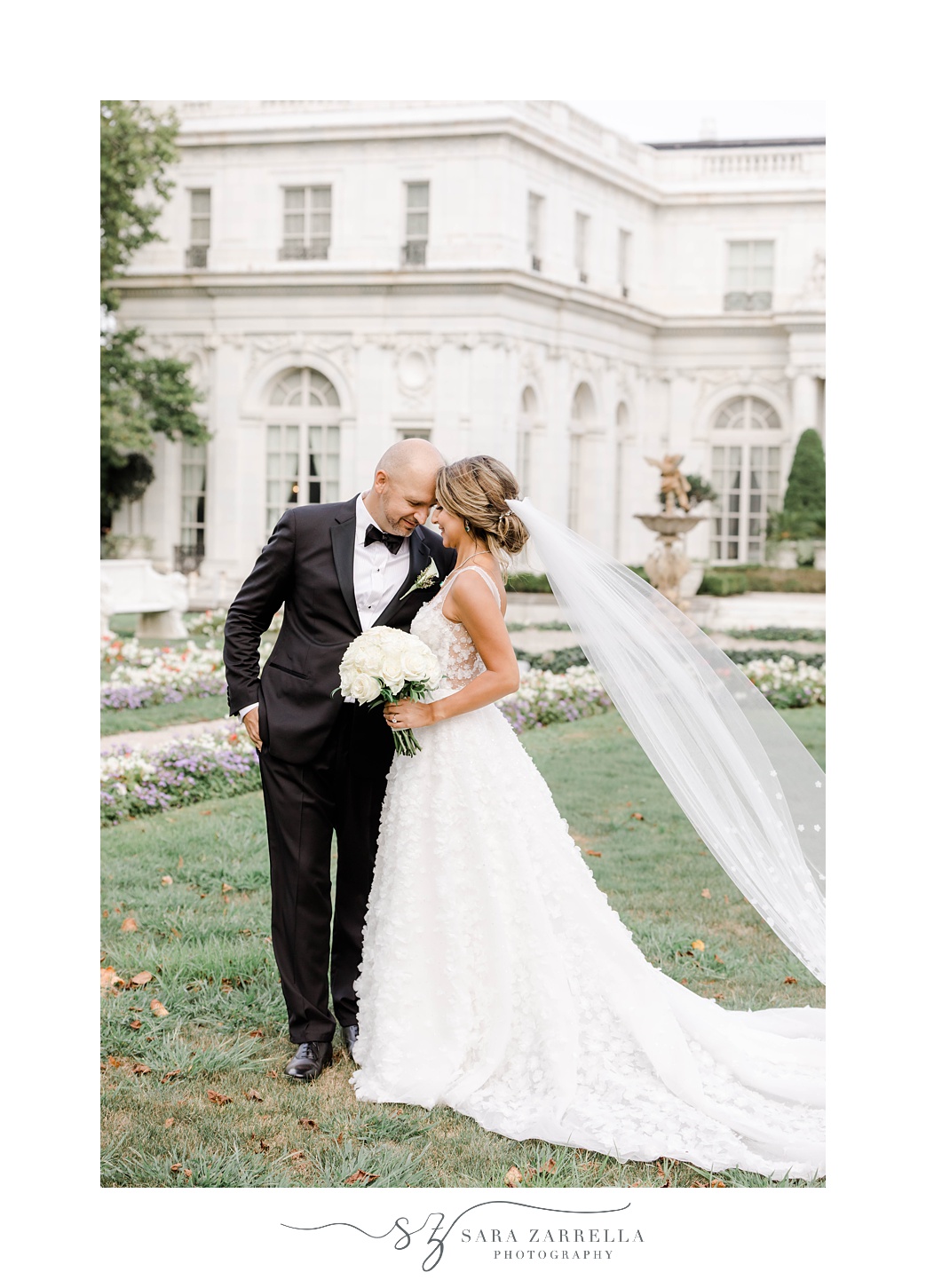 groom leans into bride during portraits at Rosecliff Mansion