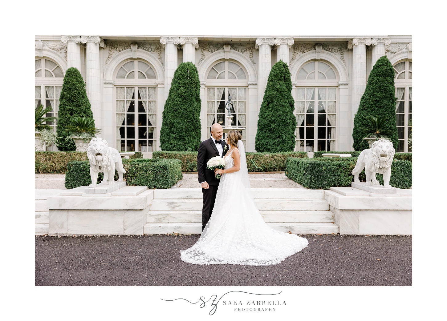 bride and groom kiss on steps of Rosecliff Mansion