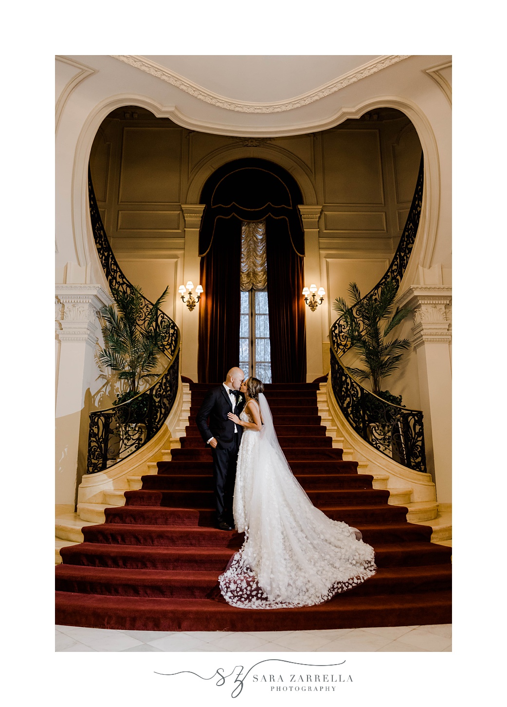 bride and groom pose on heart shaped staircase at Rosecliff Mansion