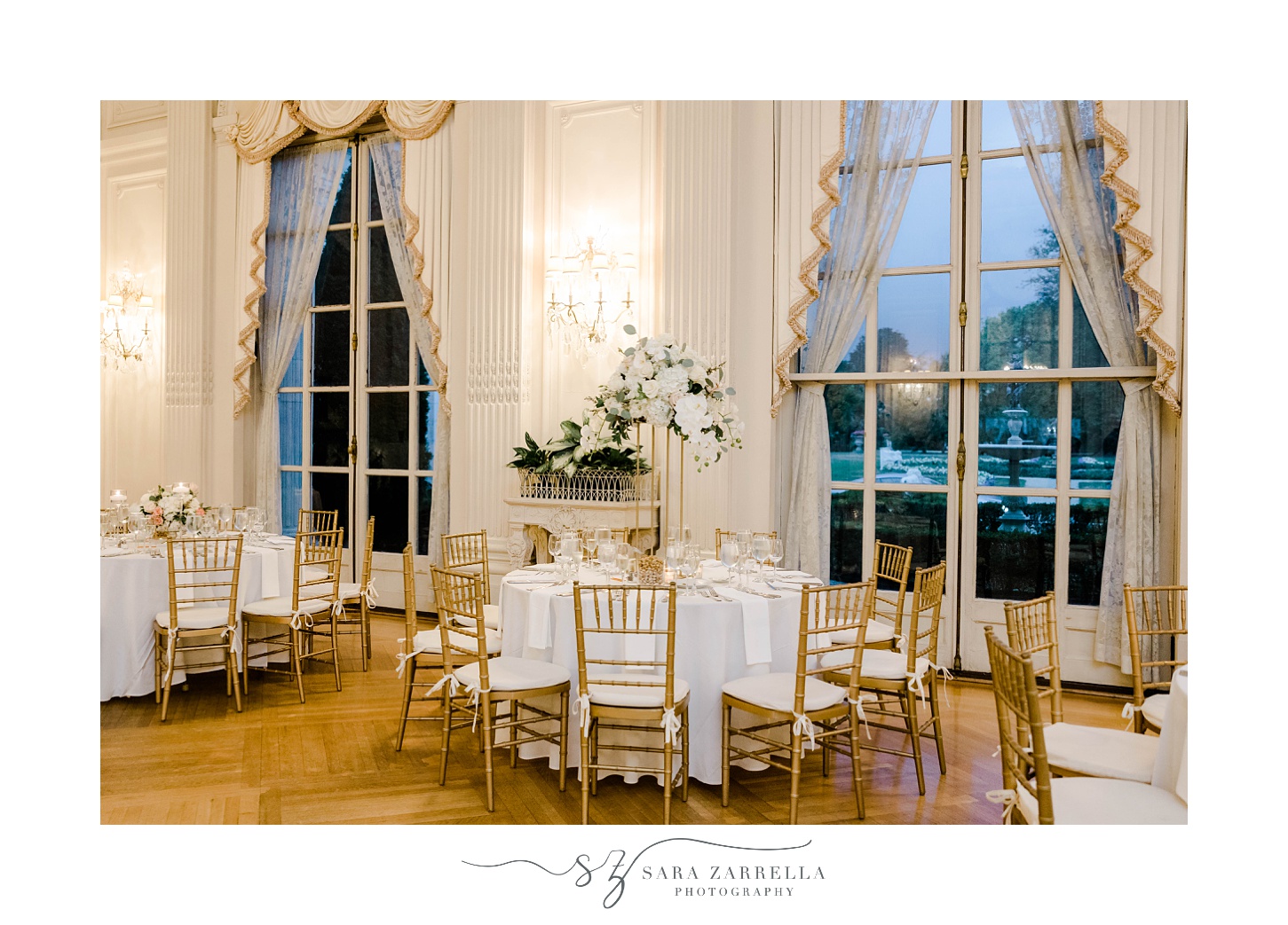 tables with white cloth and gold chivari chairs
