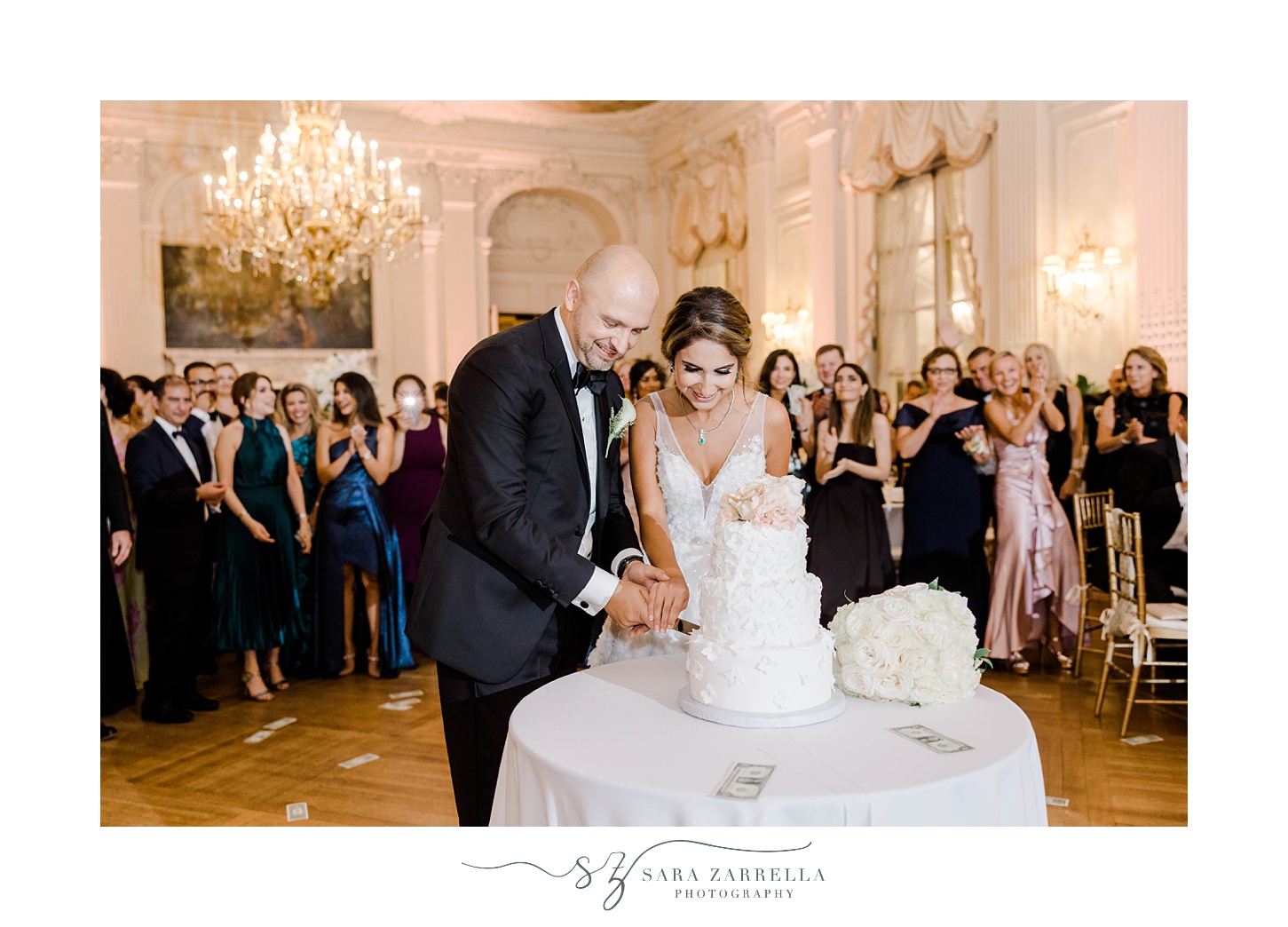 bride and groom cut wedding cake during Newport RI mansion wedding reception