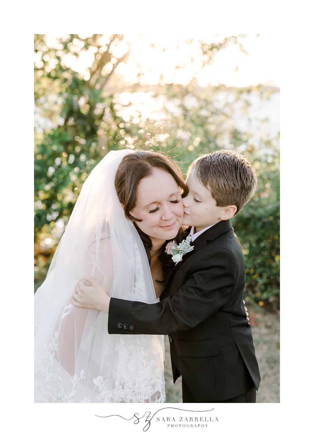 son kisses mom's cheek during RI wedding portraits 