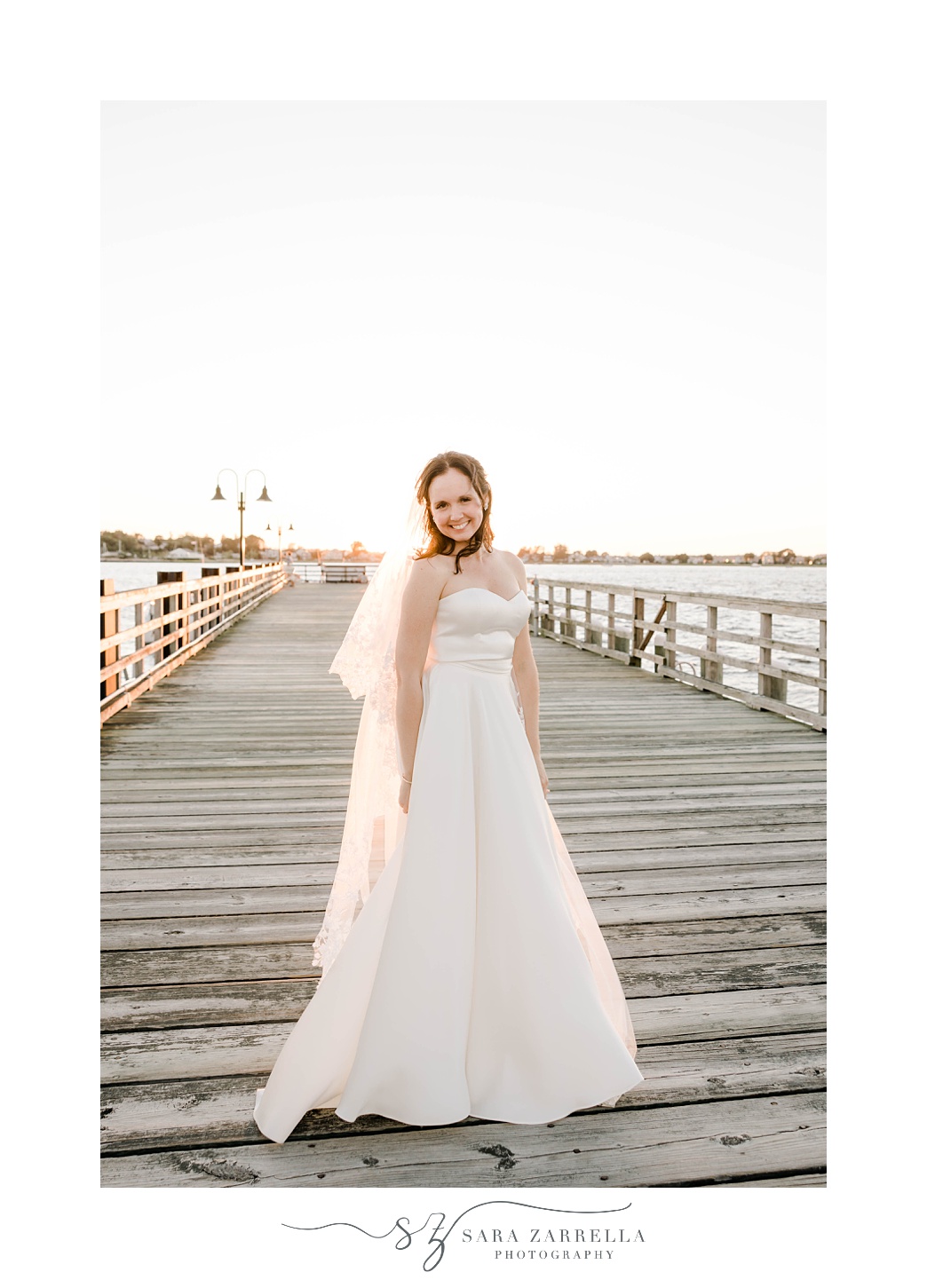 bride twirls in dress on wooden dock at The Boat House
