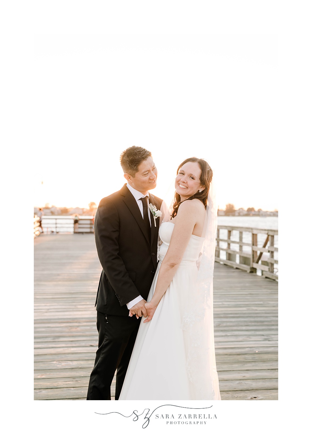 groom smiles at bride during portraits at The Boat House