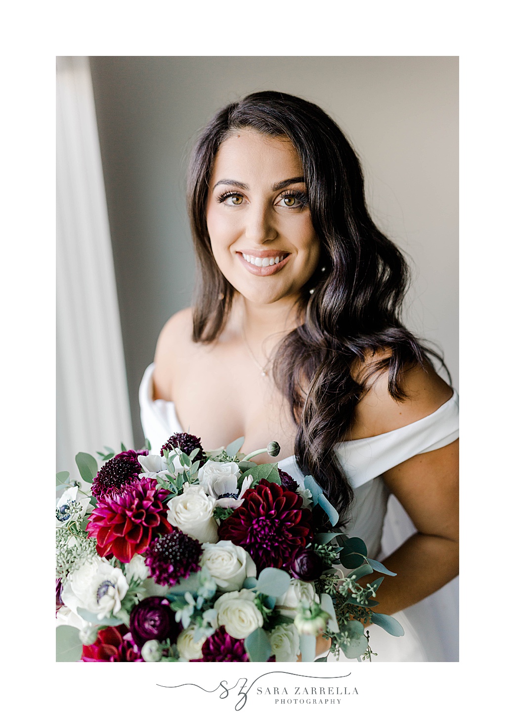 bride smiles in strapless wedding gown with fall bouquet 