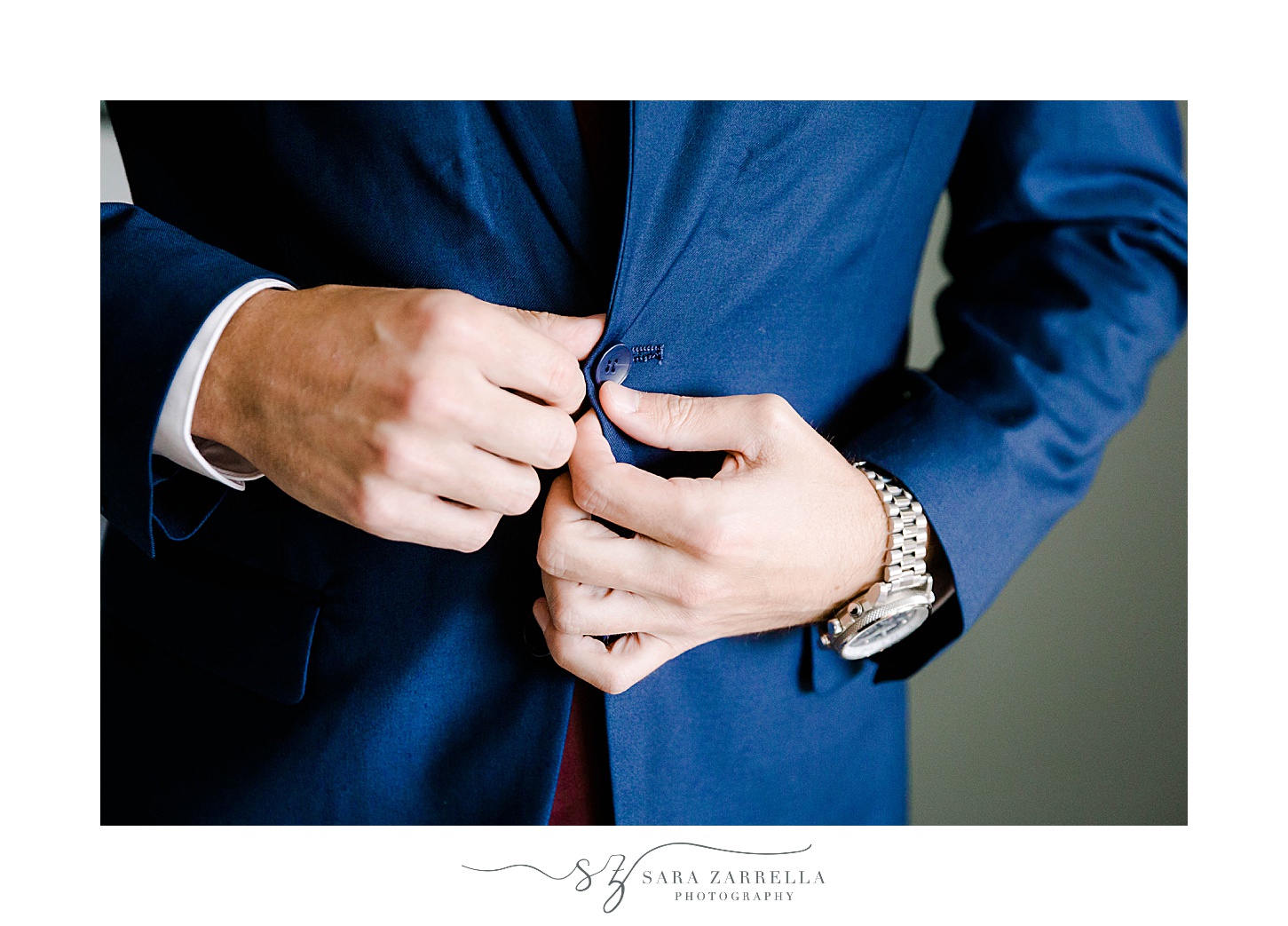 groom buttons up navy jacket at Atlantic Resort Wyndham