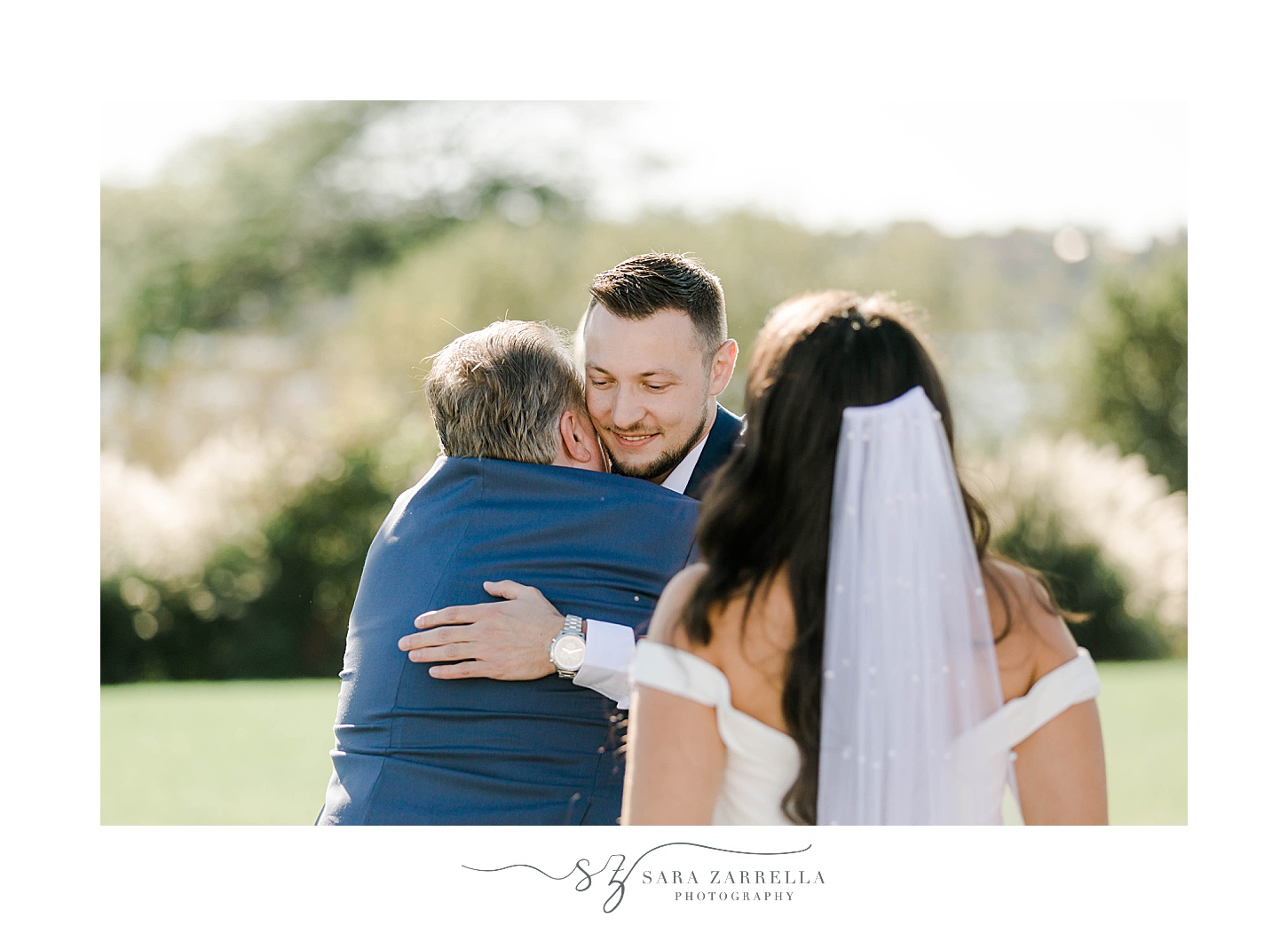 dad hugs groom during wedding ceremony at Atlantic Resort Wyndham