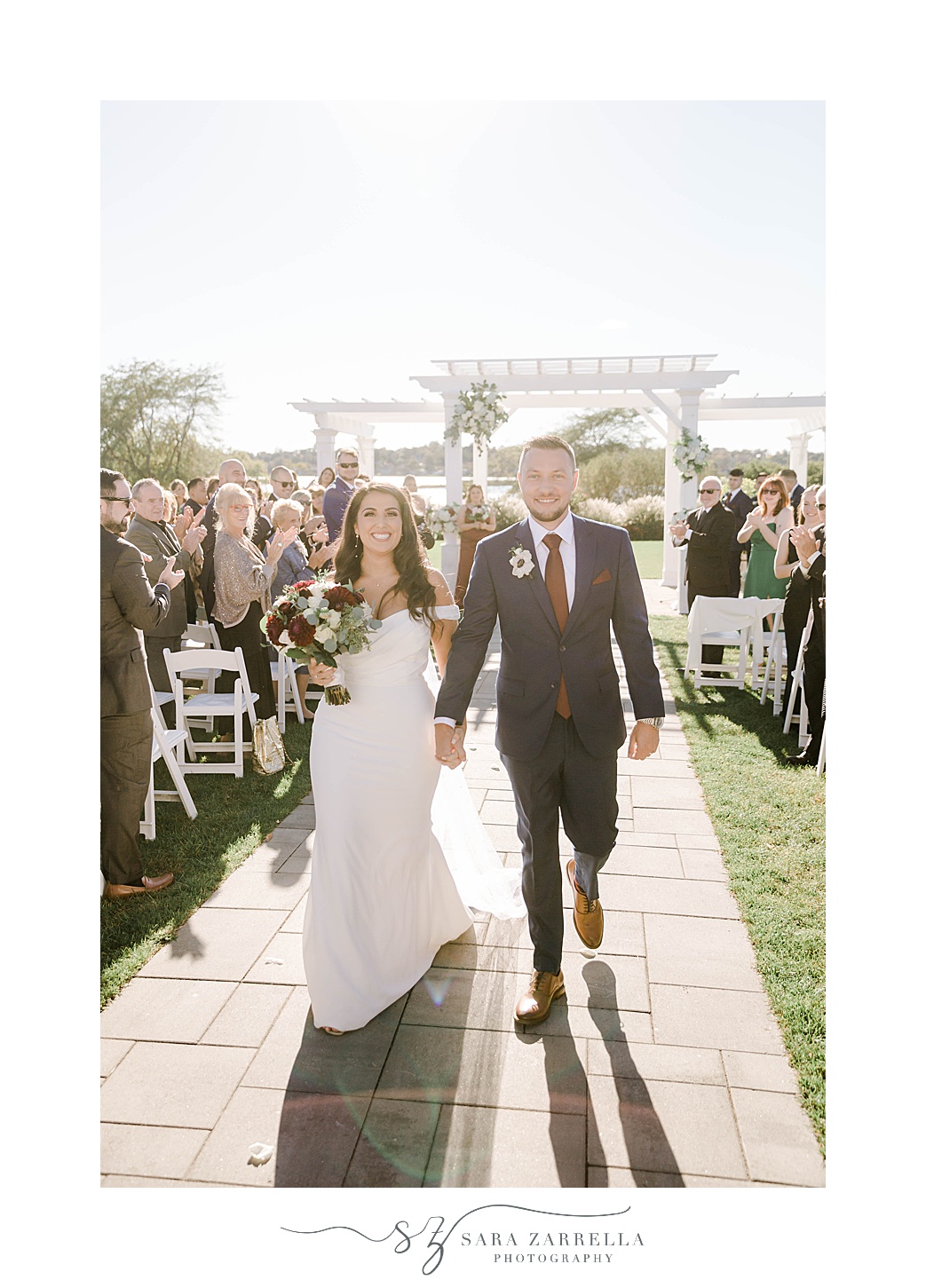 newlyweds walk up aisle after Atlantic Resort Wyndham wedding ceremony 