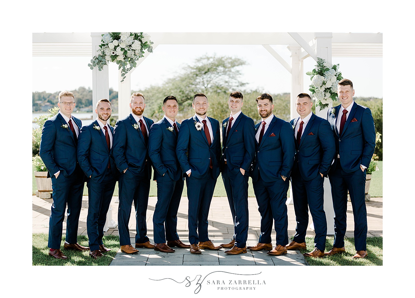 groom stands with groomsmen in navy suits at Atlantic Resort Wyndham