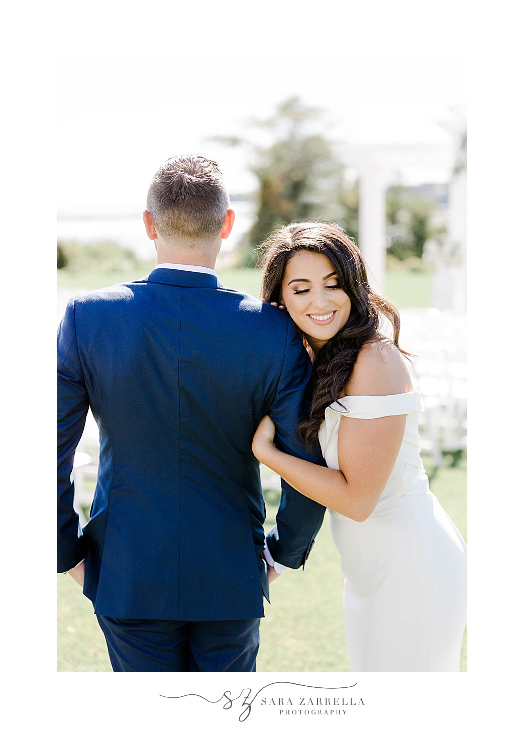 bride leans head on groom's shoulder in navy suit