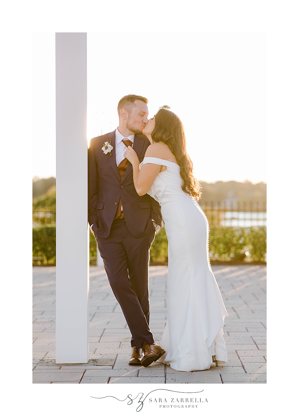 bride and groom kiss on brick patio 