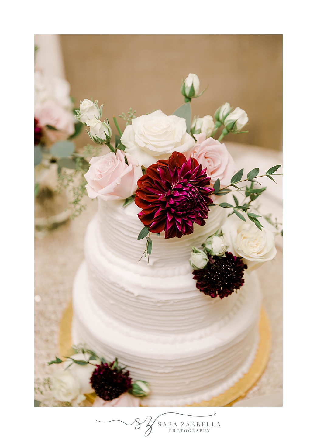 wedding cake with fall flowers on top at Atlantic Resort Wyndham