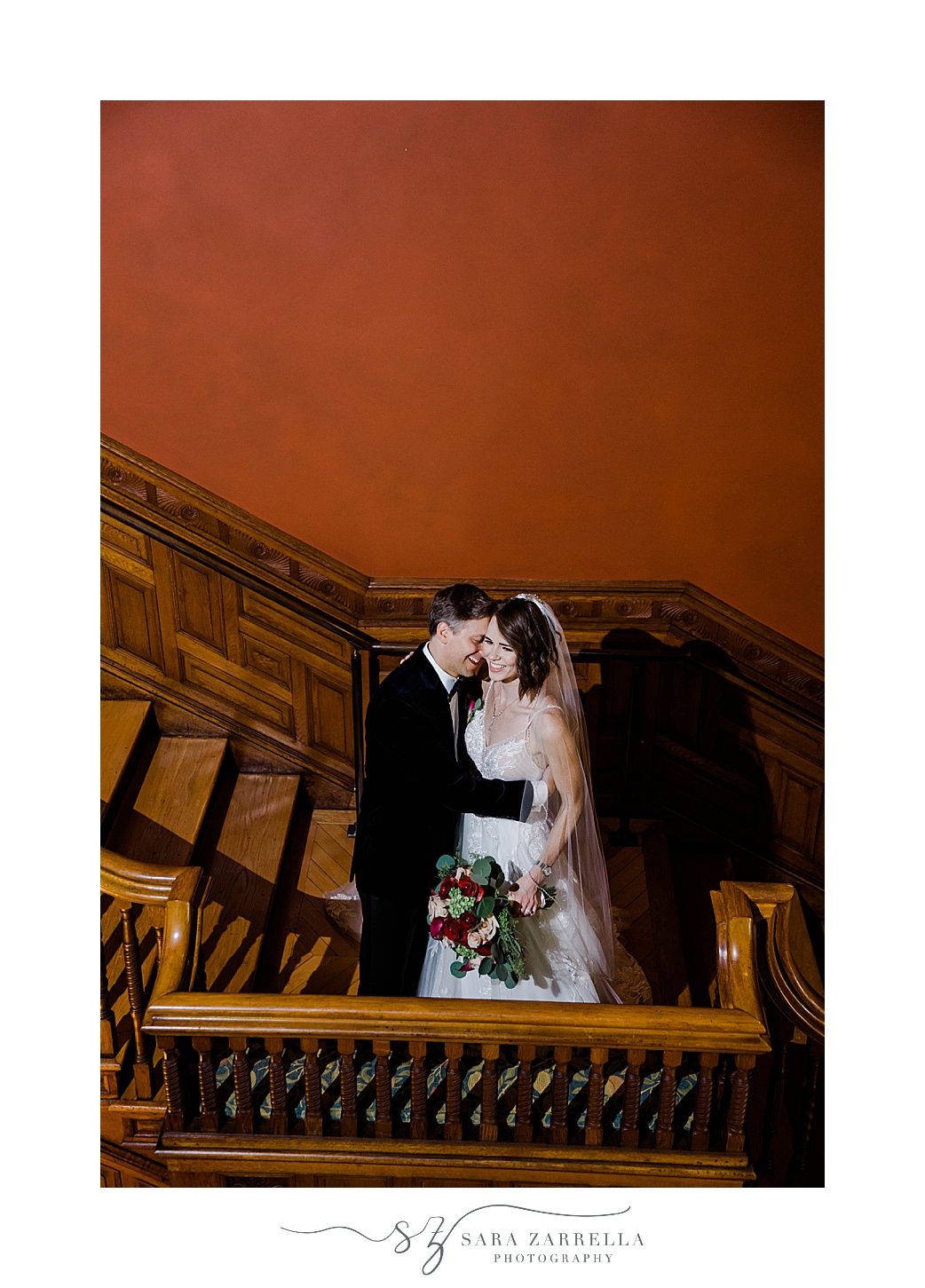 bride and groom hug on staircase in Eustis Estate