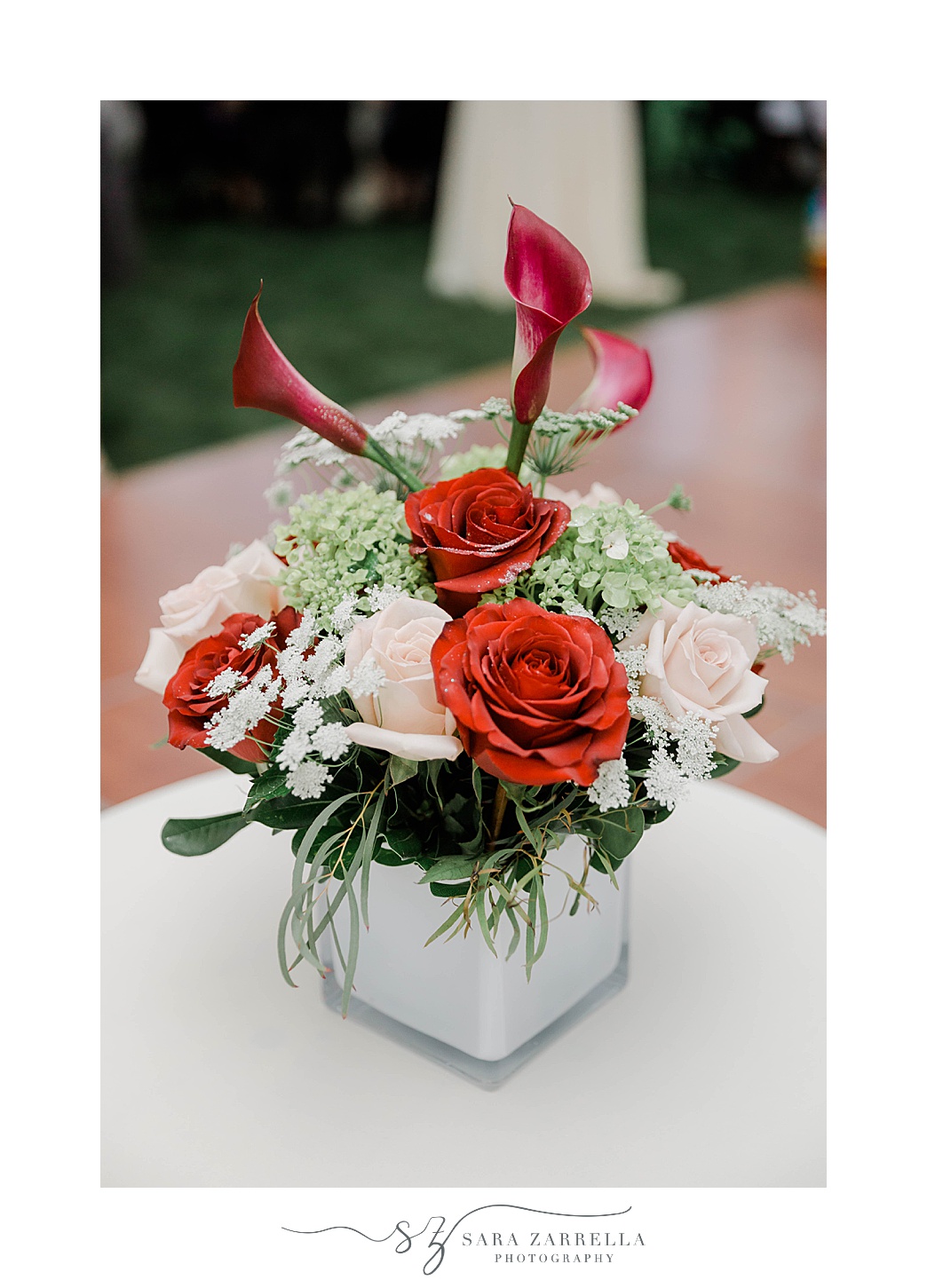 red and pink roses with red lilies for outdoor reception