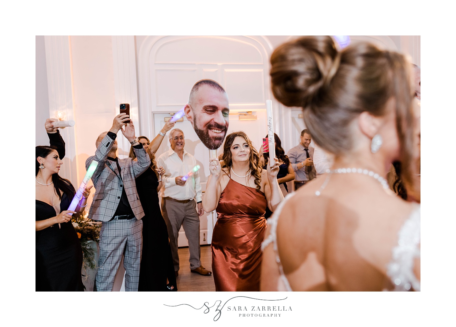 guests dance with cutout of groom's head at Newport RI wedding reception 