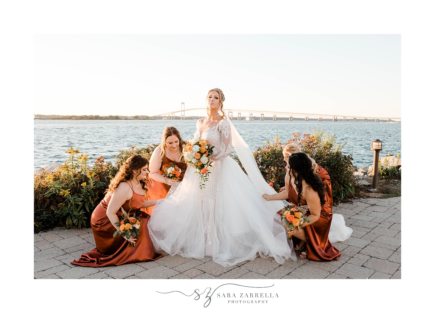 bride stands with bridesmaids in orange gowns in Newport RI