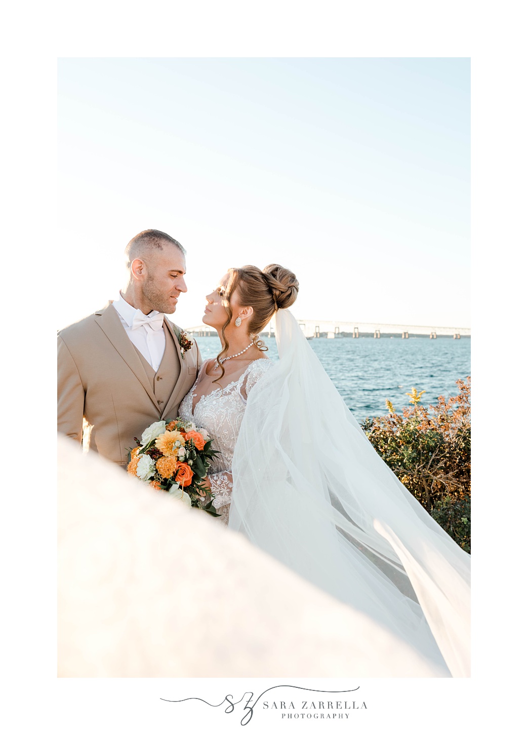 bride and groom hug during portraits outside Newport Harbor Island Resort